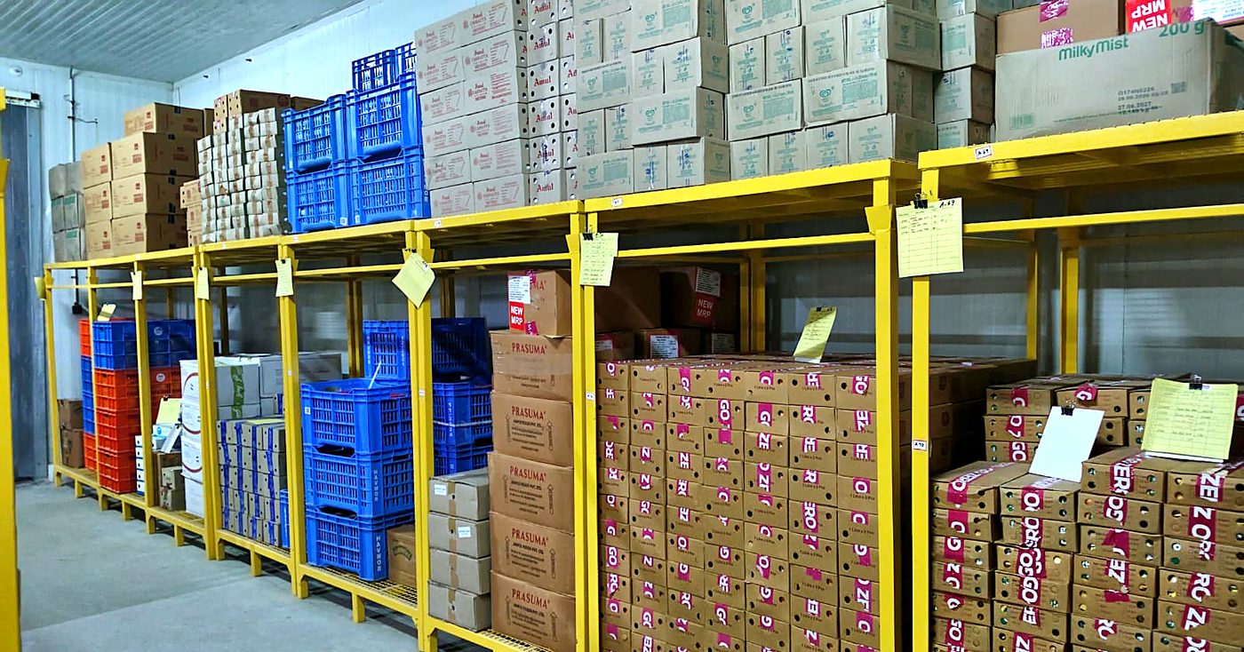 Dairy crates and cartons on racking inside the Vilva Fruits cold storage in Coimbatore