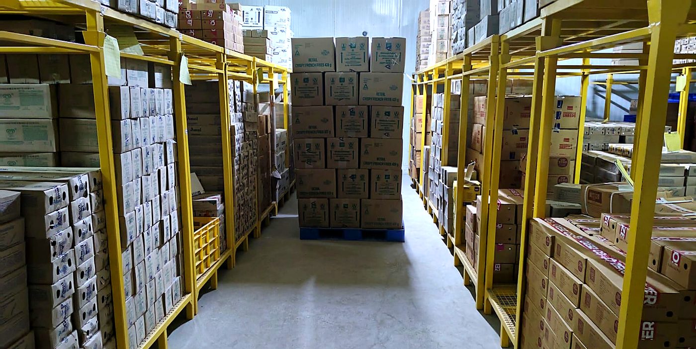 Frozen food aisle in the cold storage in Coimbatore, racked floor to ceiling with cartons